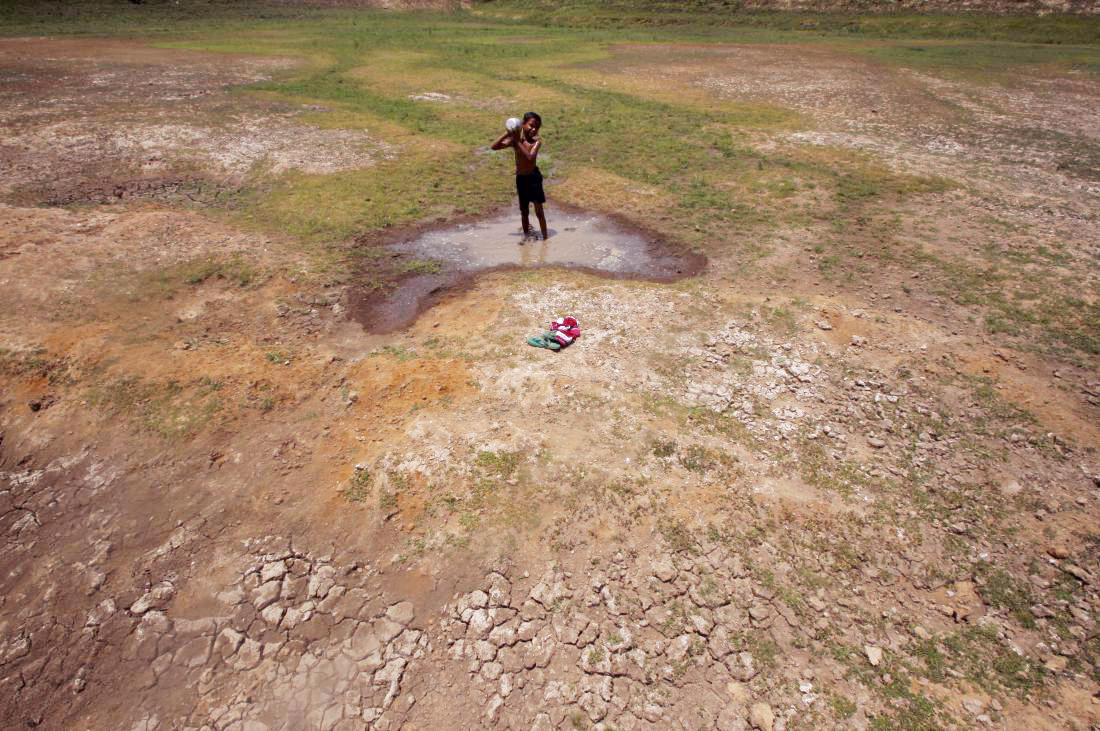 A village boy bathes in the remaining water of a dried pond to beat the heat in the outskirts of Bhubaneswar (Photo: Biswaranjan Rout/NurPhoto/Getty Images)
