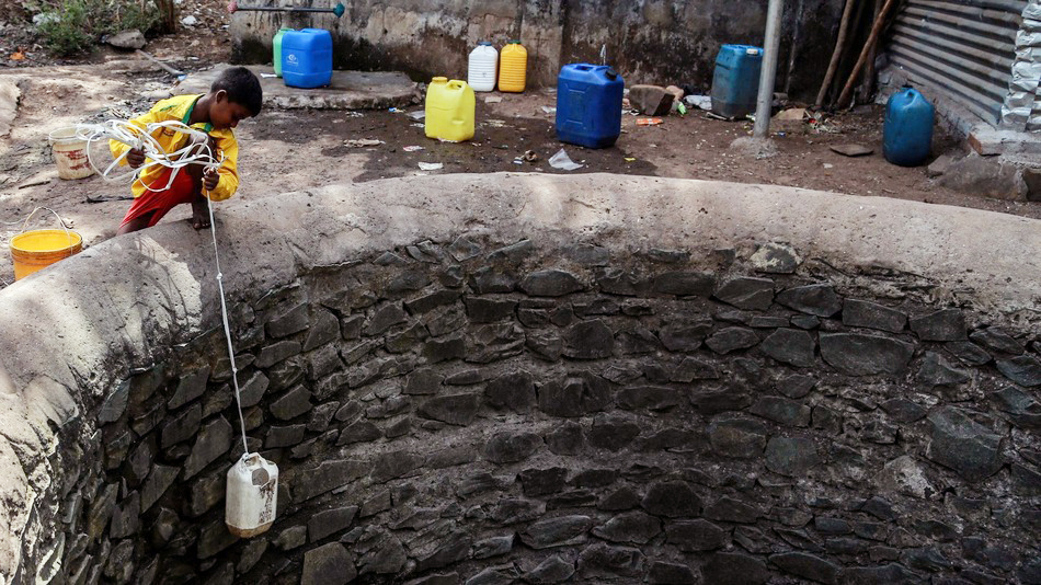 In a drought-affected village in Dindhori, Madhya Pradesh, children can be seen climbing down the walls of an almost dried-up well to fetch the remaining water. (Photo: Divyakant Solanki / EPA/Corbis Images)