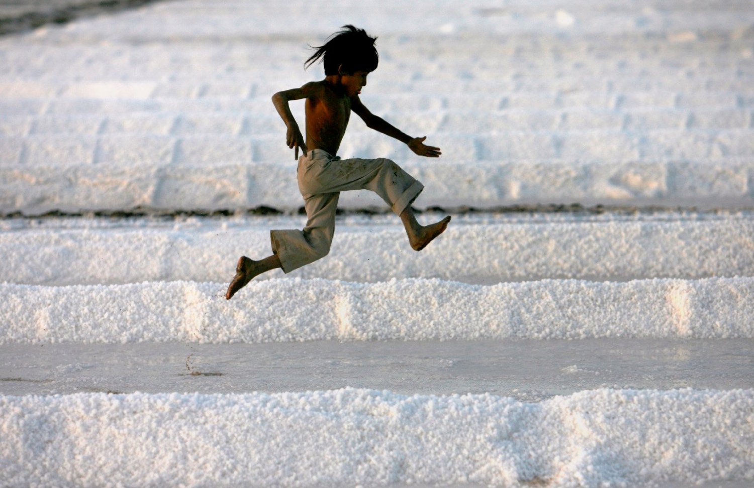 A child catapults across the salt pans of Kutch (Photo- Reuters)