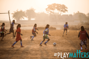 Girl children playing football