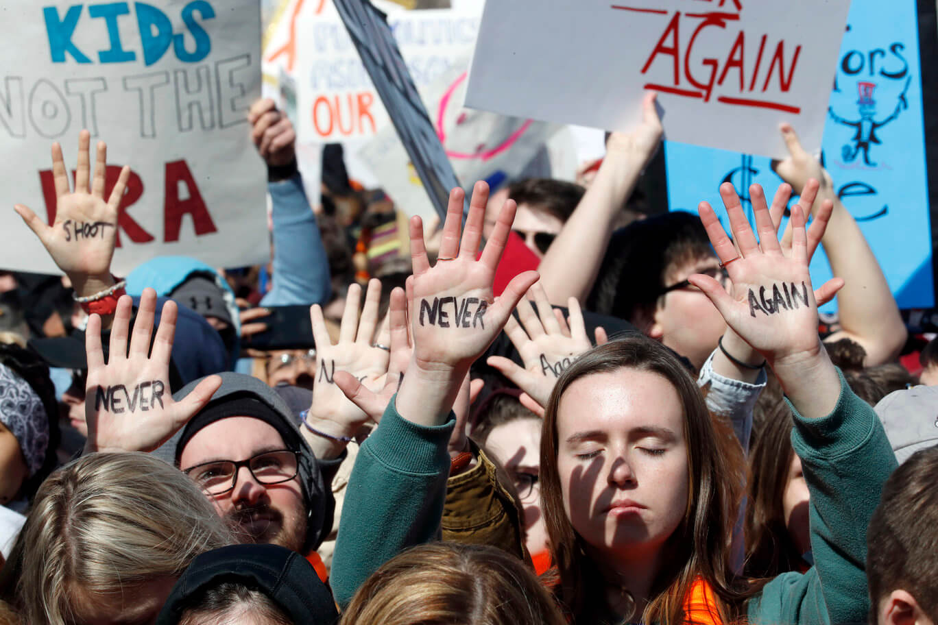 People hold their hands up with messages written on them during the March For Our Lives rally in support of gun control March in Washington. Photo courtesy-AP