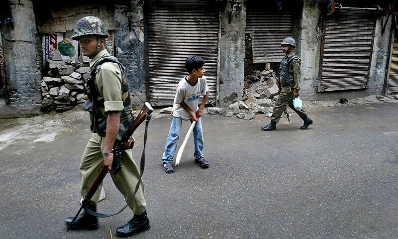 Kashmir - Children playing cricket amidst security forces