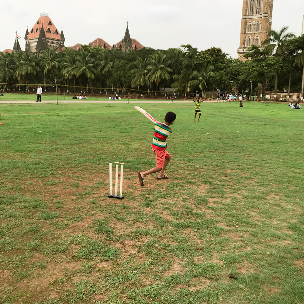 A kid playing a cricket shot