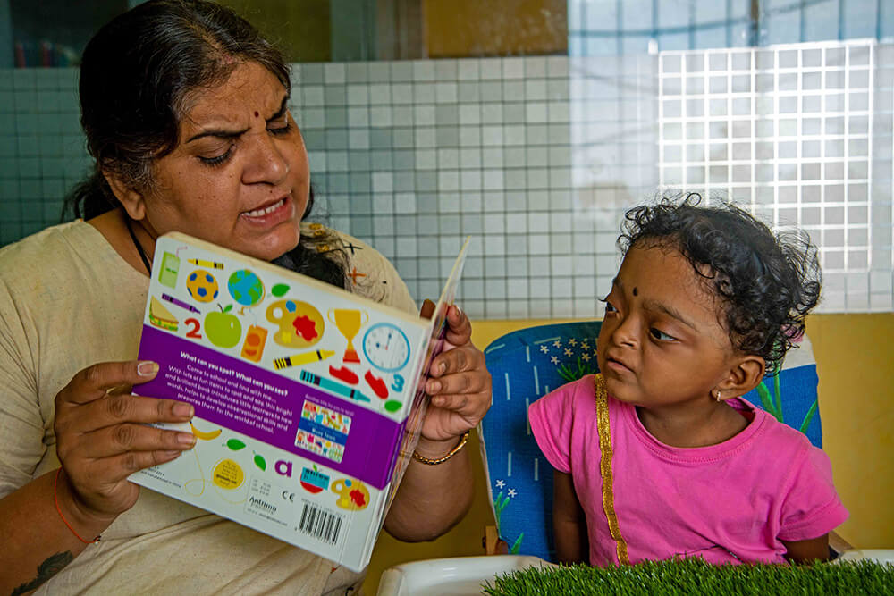 Dhvani being taught by a teacher