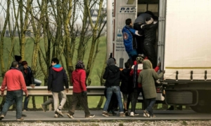 Migrants entering a trailer of a truck