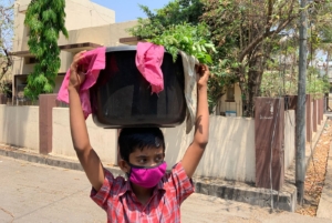 PARI - Photo of a child carrying vegetables