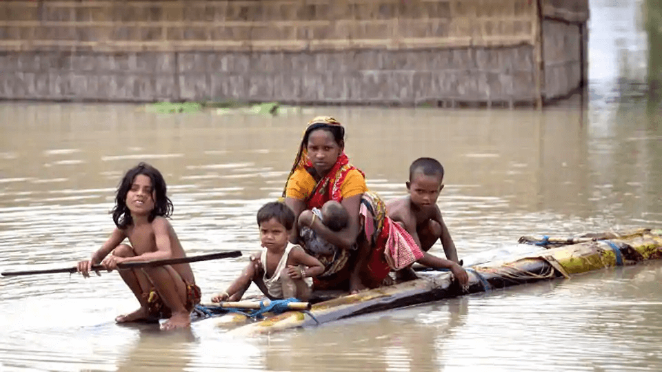 A woman carrying a baby and floating through the floods