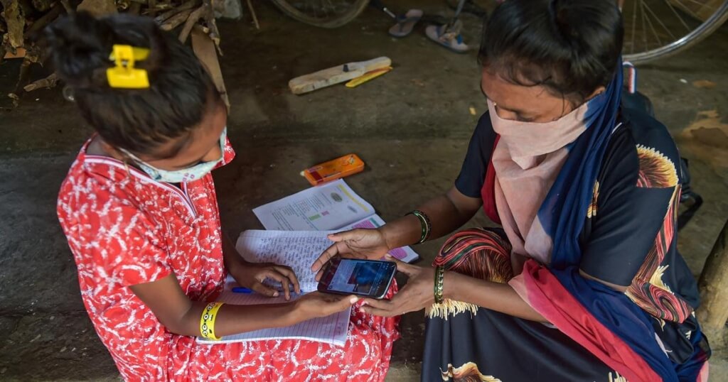 A teacher helping a child with a problem