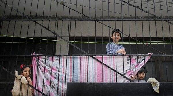 Children watching through grills