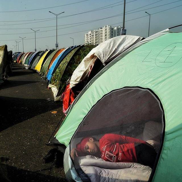 A child sleeping inside a tent